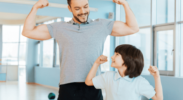 man and boy flexing arms